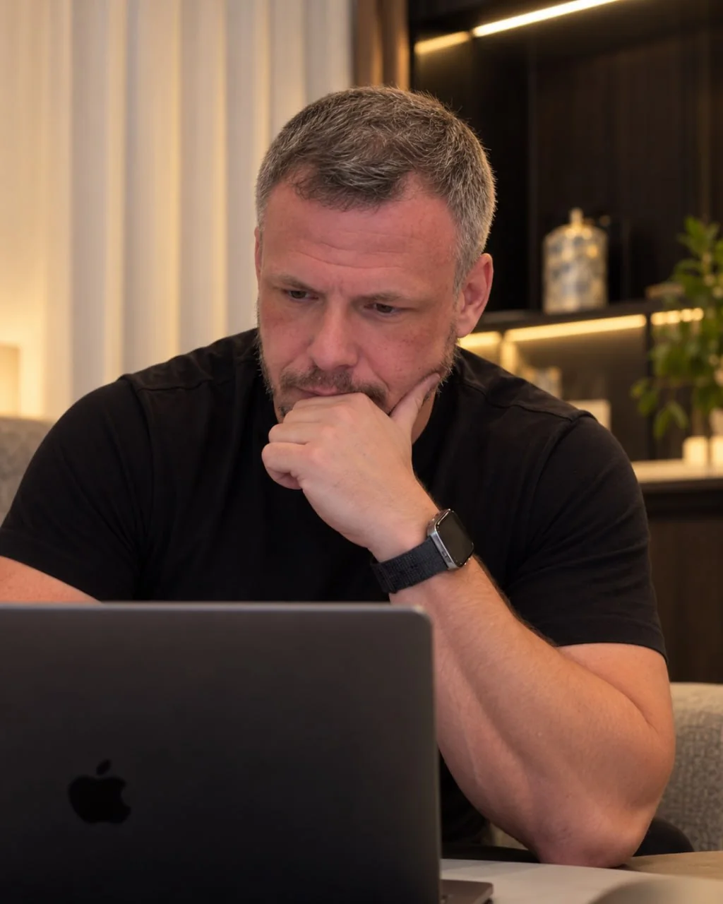 Ben Parker, Founder and CEO of Parker, thinking over a problem at his laptop